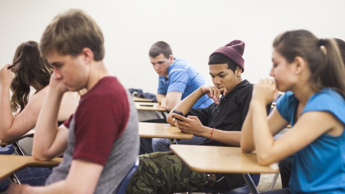 student on phone in class