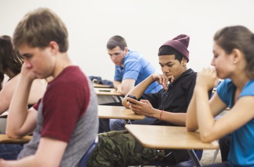 student on phone in class
