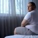 fat man on bed
