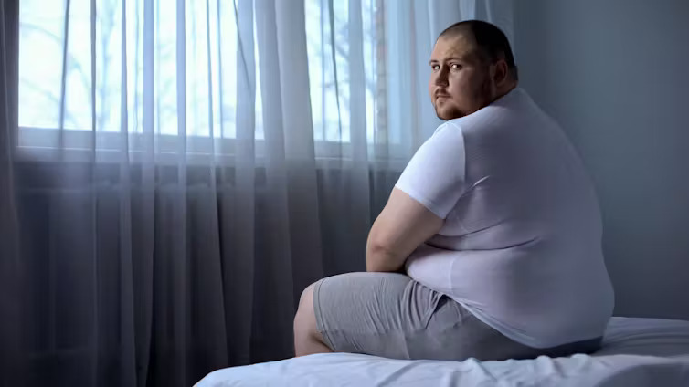 fat man on bed